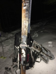 Backpack with skis and snowshoes, in the dark.