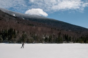Mark skis across Mud Pond while a cloud pauses above Moosilauke's south peak.