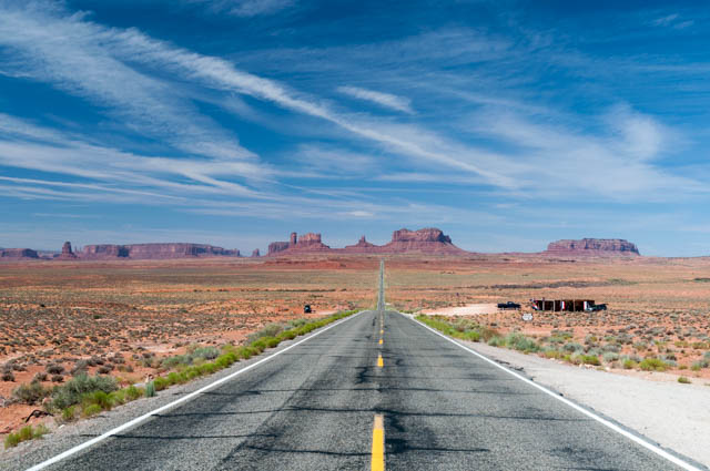 Driving through Monument Valley; some craft vendors set up alongside the road.