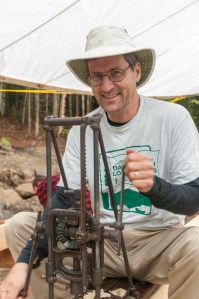 Dave uses an antique boring machine to drill mortises in one of the king posts.