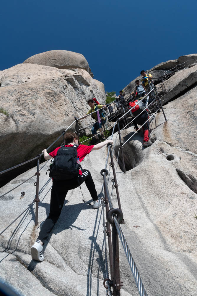 Alexis and other hikers ascend Baegundae mountain, above Seoul.