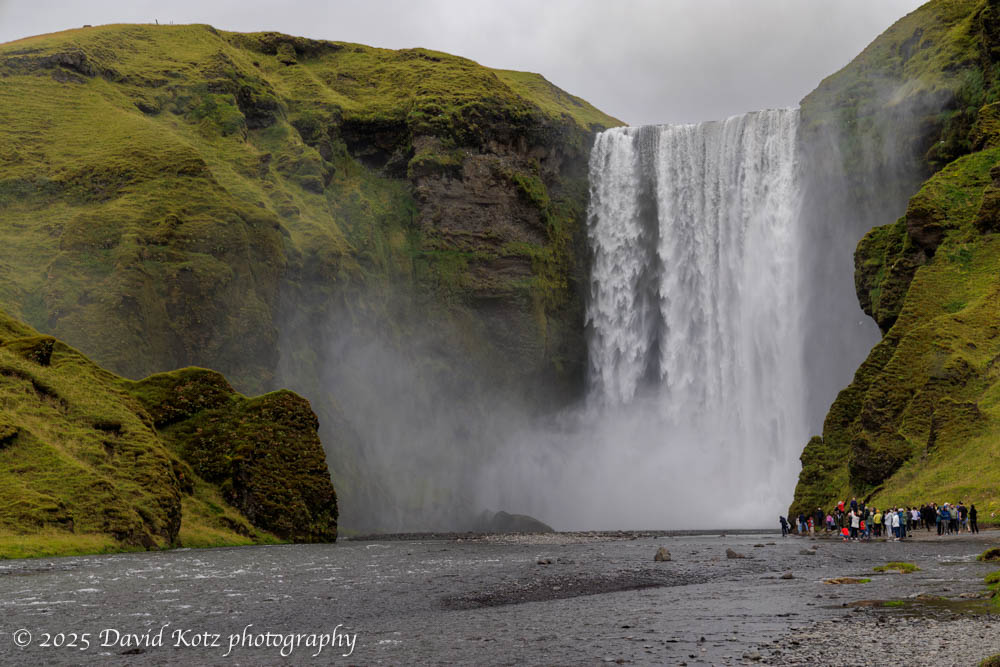 photo of Skógafoss, with some people at the base