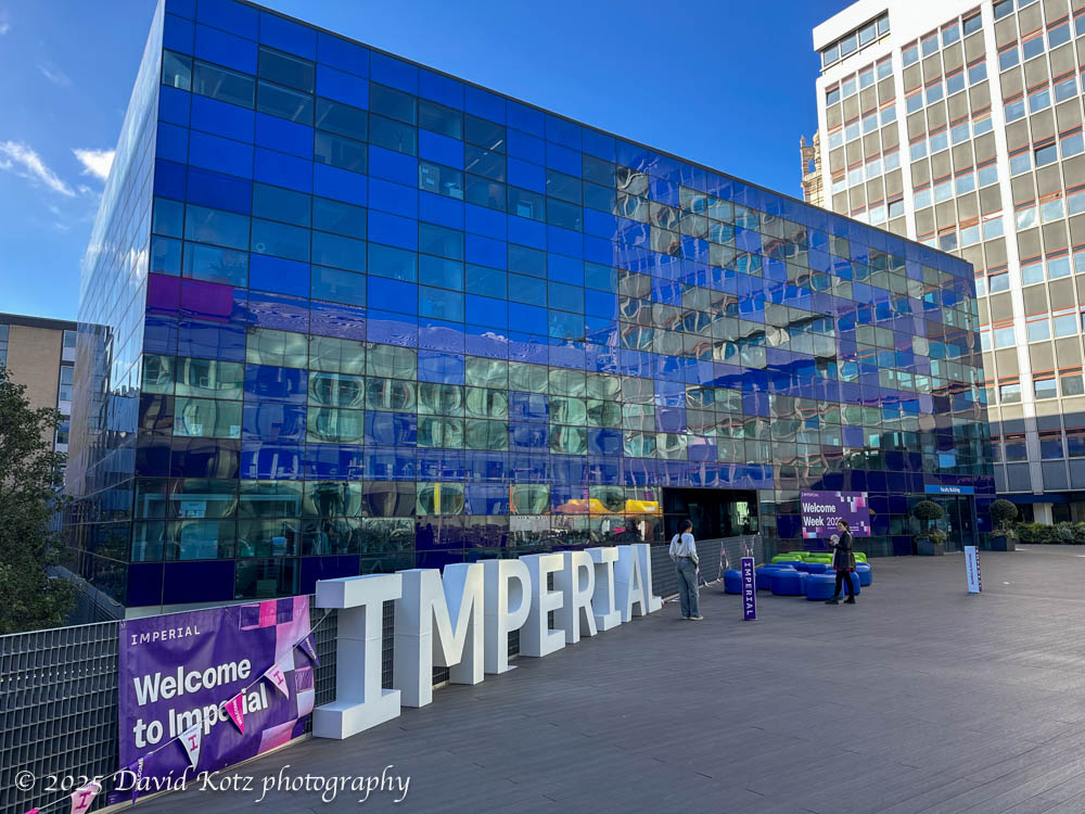Imperial College.  A glittering glass building In one of its central quads, with a big sign "Imperial College".

