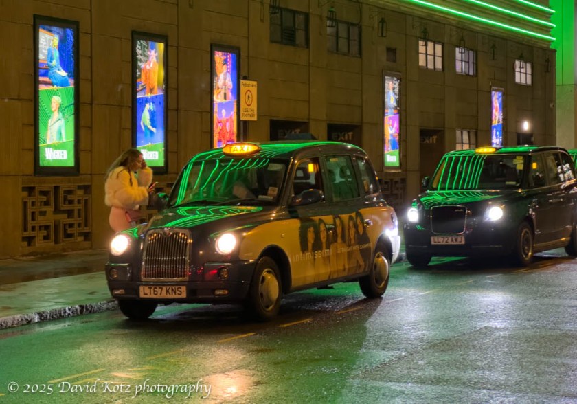 Lights from the marquee for "Wicked" reflect on the queue of taxis - Victoria Square, London.