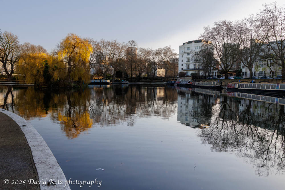 photo of Little Venice pond, with overhanging trees, houseboats moored to one side, and homes beyond