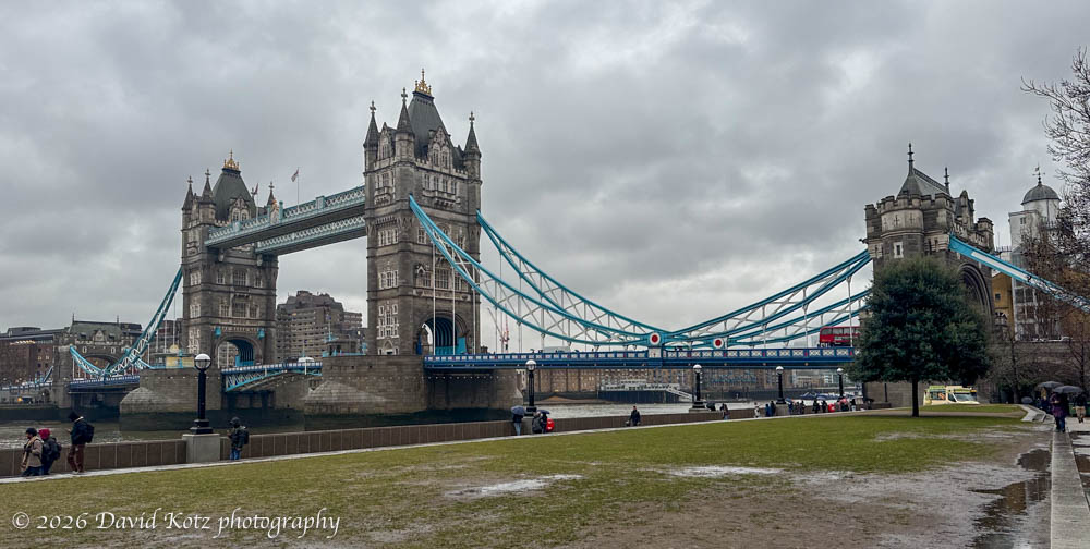view of the whole Tower Bridge from the southern shore.  cloudy and drizzly day.